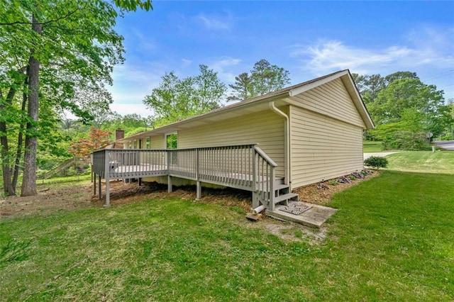 view of side of property with a yard and a deck
