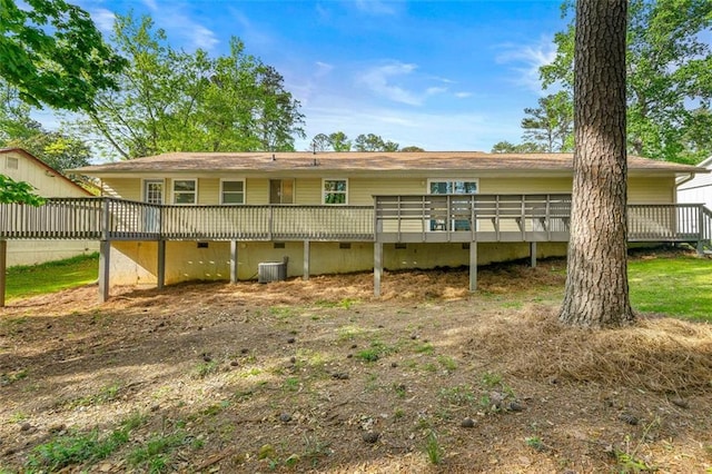 rear view of house with central AC unit, a deck, and crawl space
