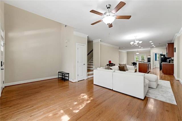 3642 Princeton Ave, Atlanta, GA 30337 - living room featuring ornamental molding, stairway, light wood-style floors, a chandelier, and a ceiling fan