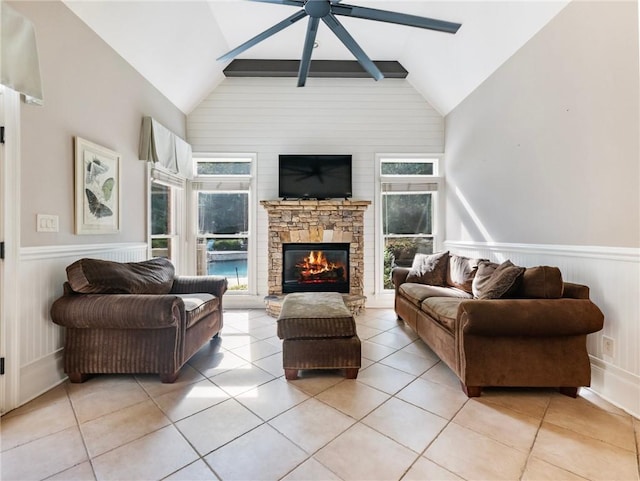 living room with light tile patterned flooring, high vaulted ceiling, a fireplace, and ceiling fan