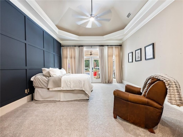 carpeted bedroom with a raised ceiling, ornamental molding, access to exterior, and ceiling fan