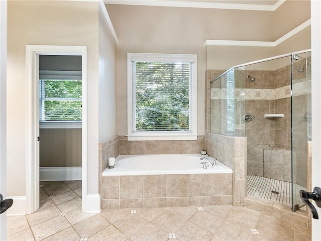 bathroom with ornamental molding and separate shower and tub