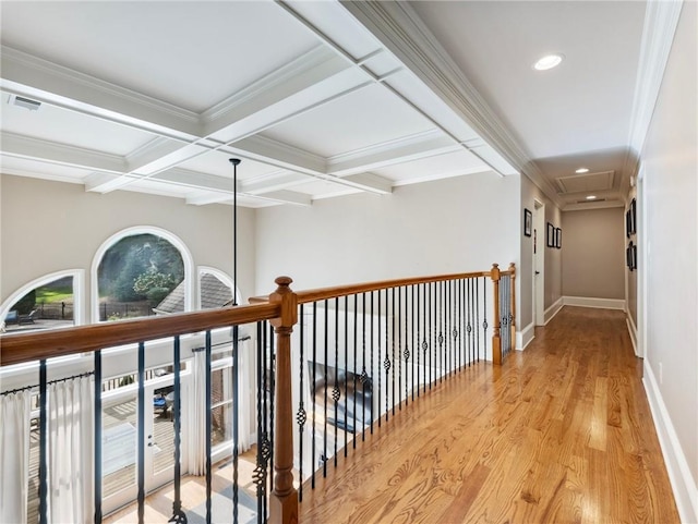 hall with beamed ceiling, ornamental molding, coffered ceiling, and light hardwood / wood-style flooring