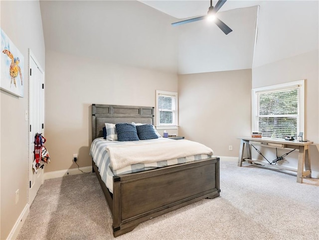 bedroom with ceiling fan, high vaulted ceiling, and carpet