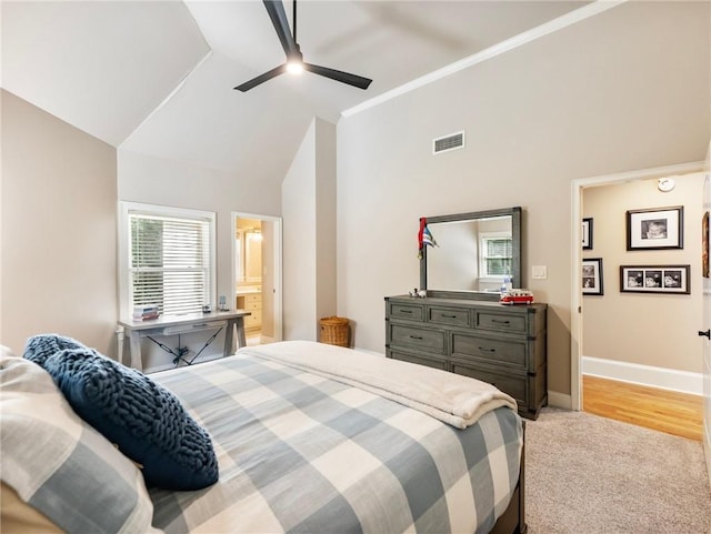 bedroom with light carpet, high vaulted ceiling, and ceiling fan