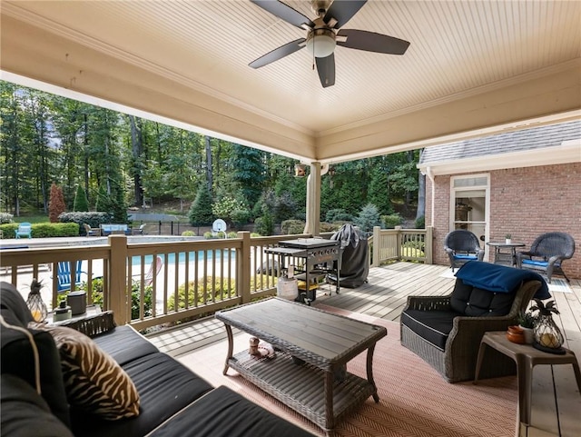 wooden terrace with an outdoor hangout area and ceiling fan