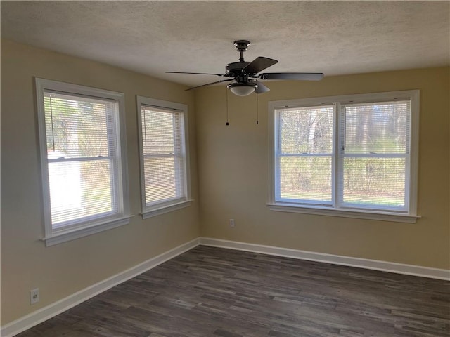 unfurnished room with a healthy amount of sunlight, dark hardwood / wood-style floors, and a textured ceiling