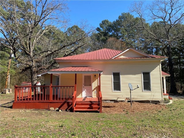 rear view of property featuring a yard