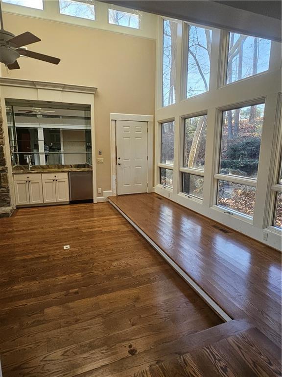 foyer with ceiling fan, a high ceiling, and dark hardwood / wood-style floors