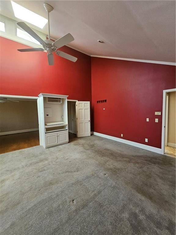 unfurnished bedroom featuring ceiling fan, crown molding, carpet, and high vaulted ceiling