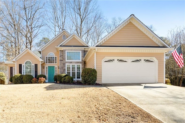 traditional-style house with a garage, concrete driveway, and stone siding