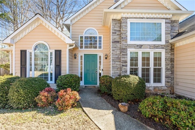 view of exterior entry featuring stone siding