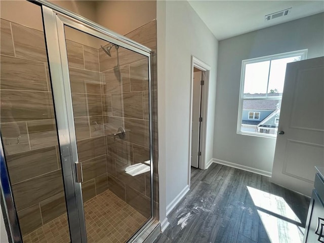 bathroom with hardwood / wood-style floors and walk in shower