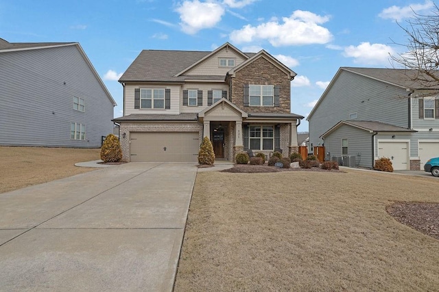 craftsman-style house with a garage, cooling unit, and a front lawn