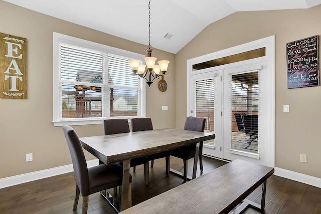 dining area with lofted ceiling, dark wood-style floors, baseboards, and a chandelier