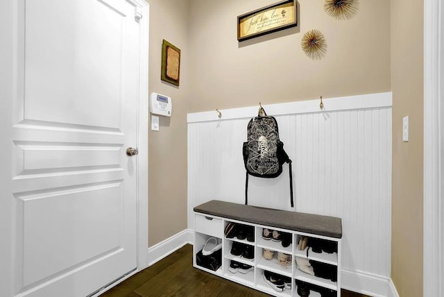 mudroom with dark wood-style flooring and baseboards