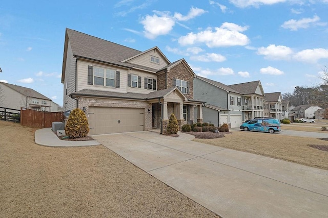 craftsman inspired home featuring a garage and a front lawn