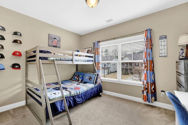 bedroom featuring visible vents, baseboards, and light colored carpet