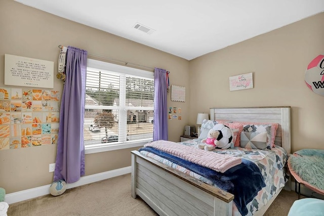 bedroom with light colored carpet, visible vents, and baseboards