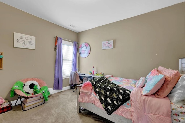 bedroom featuring light carpet and baseboards