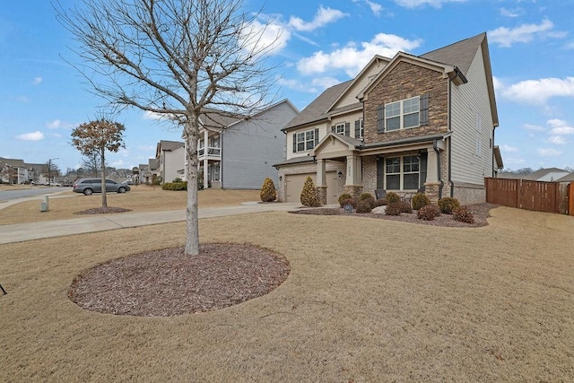 craftsman house featuring a garage and a front yard