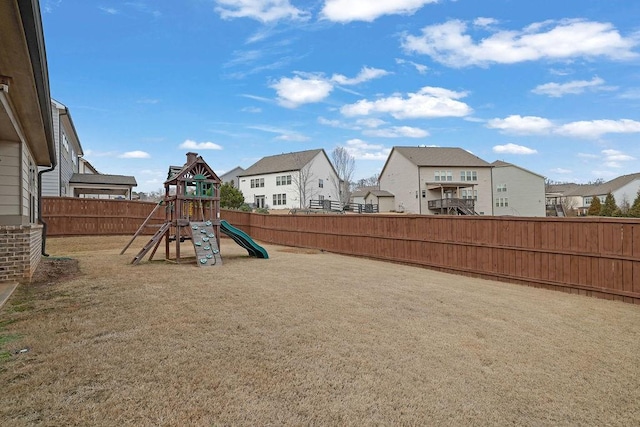 view of play area featuring a fenced backyard and a residential view