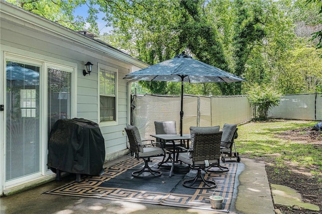 200 Robin Hood Ln, Hampton, GA 30228 - fenced backyard featuring a patio area, outdoor dining space, and a grill