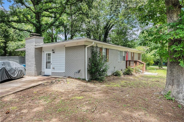 200 Robin Hood Ln, Hampton, GA 30228 - view of front of house featuring a chimney and brick siding