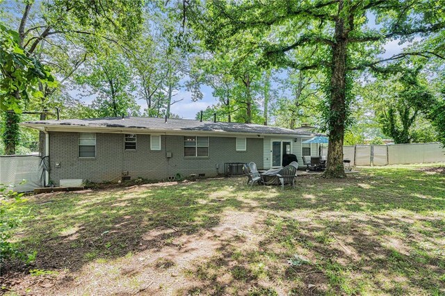 200 Robin Hood Ln, Hampton, GA 30228 - rear view of house featuring a fenced backyard, brick siding, and crawl space