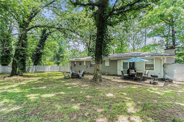 200 Robin Hood Ln, Hampton, GA 30228 - back of property with a fenced backyard, a chimney, and a patio area