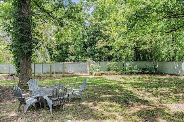 200 Robin Hood Ln, Hampton, GA 30228 - fenced backyard featuring an outdoor fire pit