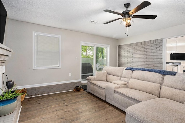 200 Robin Hood Ln, Hampton, GA 30228 - living area featuring wood finished floors, a ceiling fan, and a textured ceiling