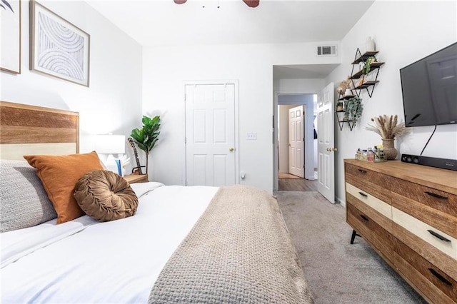 carpeted bedroom featuring ceiling fan and a closet