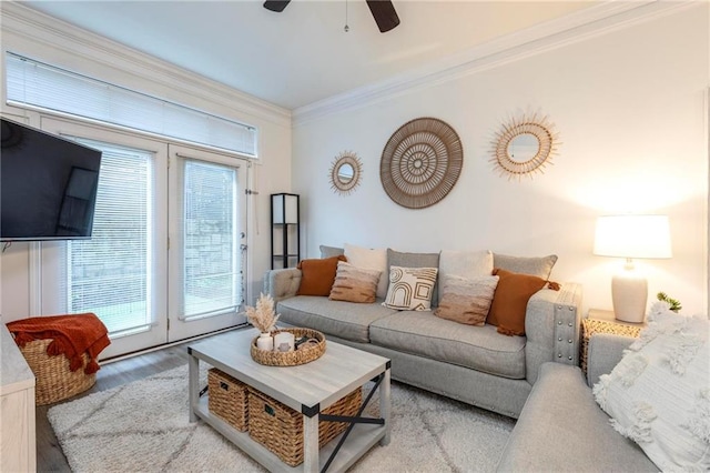 living room featuring light hardwood / wood-style flooring, a wealth of natural light, crown molding, and ceiling fan