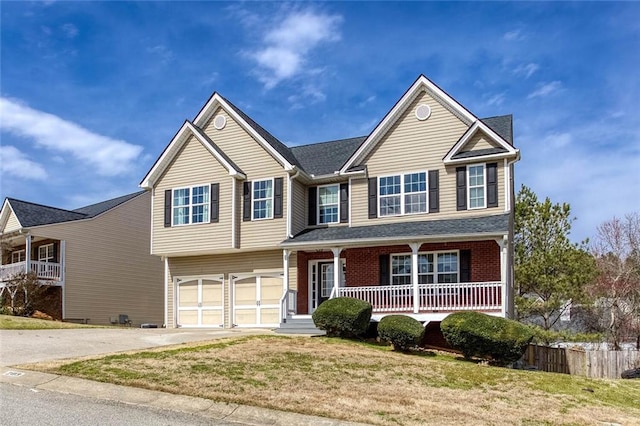 view of front of home featuring brick siding, concrete driveway, a front yard, covered porch, and an attached garage