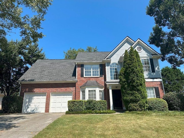 view of front of house with a garage and a front lawn