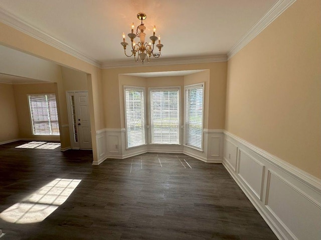 unfurnished dining area with an inviting chandelier, dark wood-type flooring, and ornamental molding