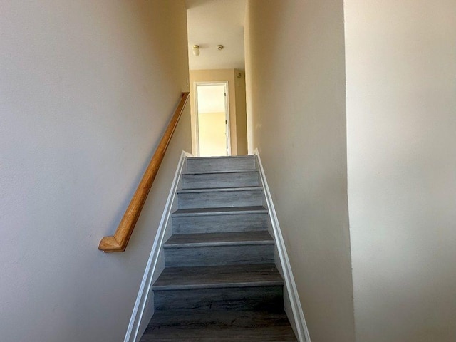 stairs featuring hardwood / wood-style floors