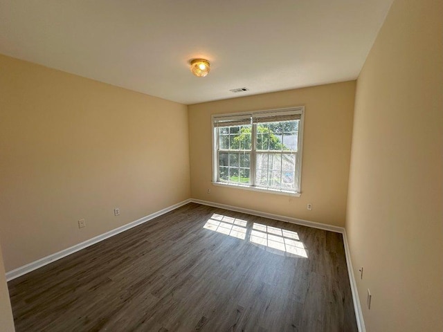 empty room featuring dark hardwood / wood-style flooring