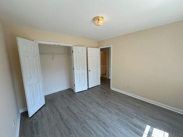 unfurnished bedroom with a closet and hardwood / wood-style flooring