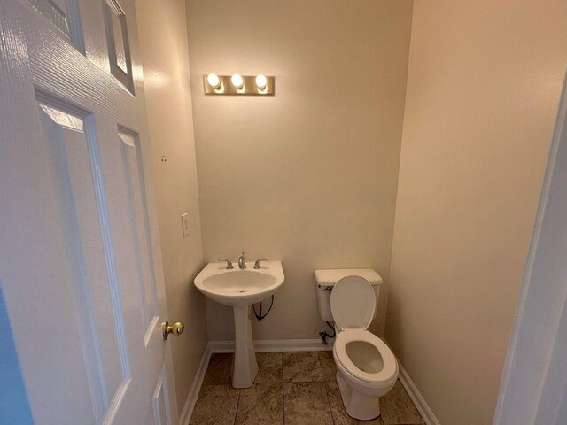 bathroom featuring tile patterned flooring and toilet