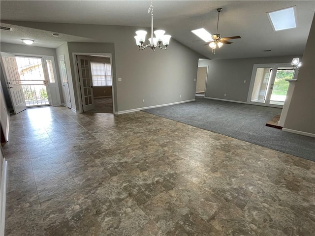 7123 Woodridge Ln, Union City, GA 30291 - carpeted empty room with a chandelier, vaulted ceiling, a ceiling fan, and a skylight