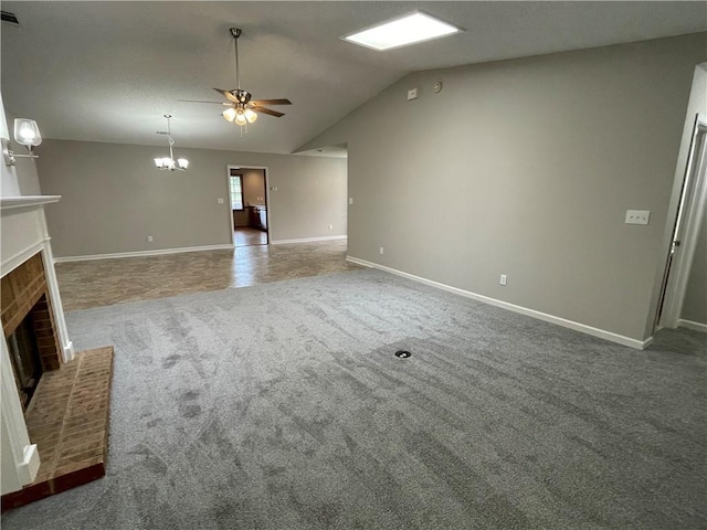 7123 Woodridge Ln, Union City, GA 30291 - unfurnished living room with a brick fireplace, carpet floors, ceiling fan, lofted ceiling, and a chandelier