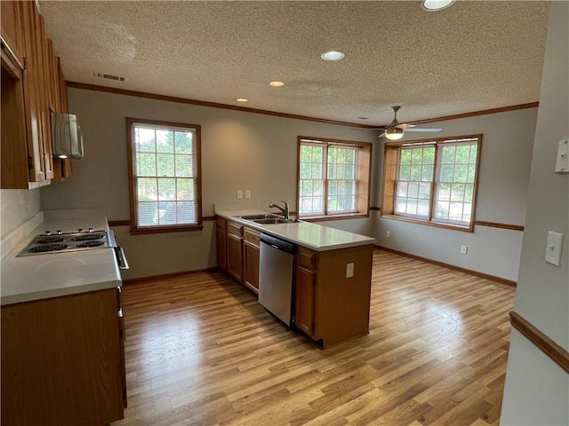 7123 Woodridge Ln, Union City, GA 30291 - kitchen with stainless steel dishwasher, a peninsula, crown molding, a textured ceiling, and light wood-style flooring