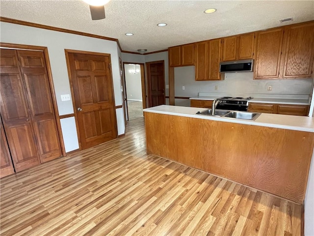 7123 Woodridge Ln, Union City, GA 30291 - kitchen with stainless steel microwave, brown cabinets, light wood finished floors, light countertops, and a textured ceiling