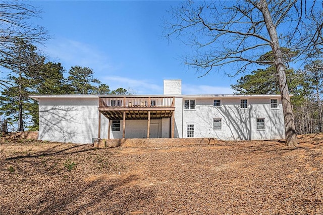 9640 Cedar Grove Rd, Fairburn, GA 30213 - rear view of property with a wooden deck, a chimney, and stucco siding