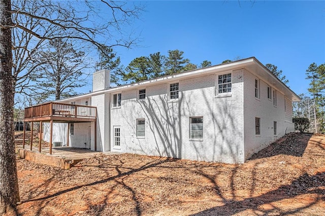 9640 Cedar Grove Rd, Fairburn, GA 30213 - back of property featuring a chimney, a deck, and brick siding