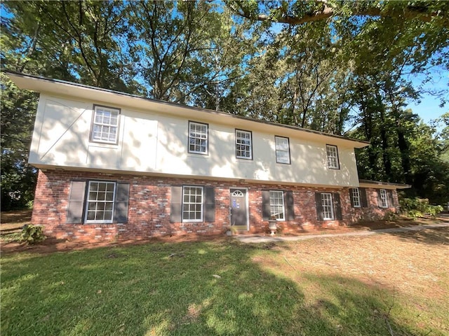 view of front of property featuring a front lawn and brick siding