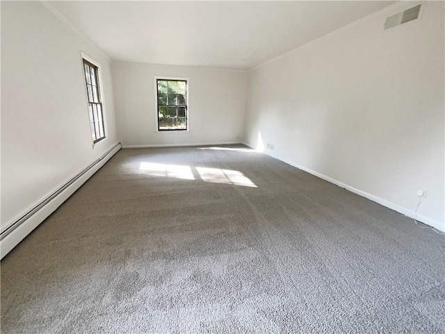 carpeted spare room with a baseboard radiator