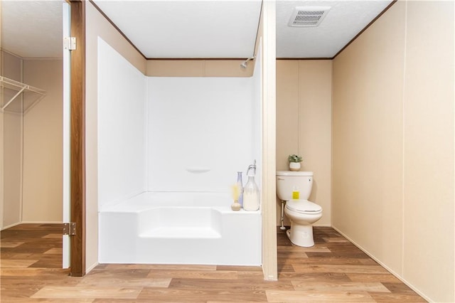 bathroom with wood-type flooring and toilet